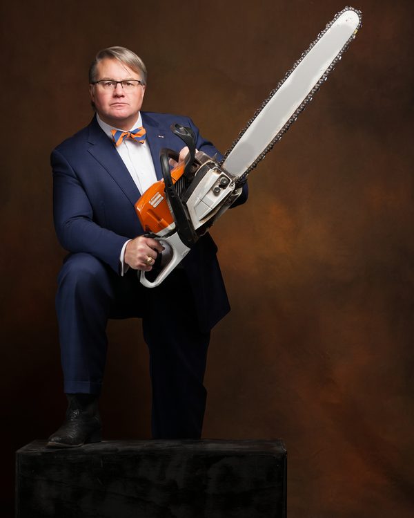 Mark Braswell holding a chainsaw