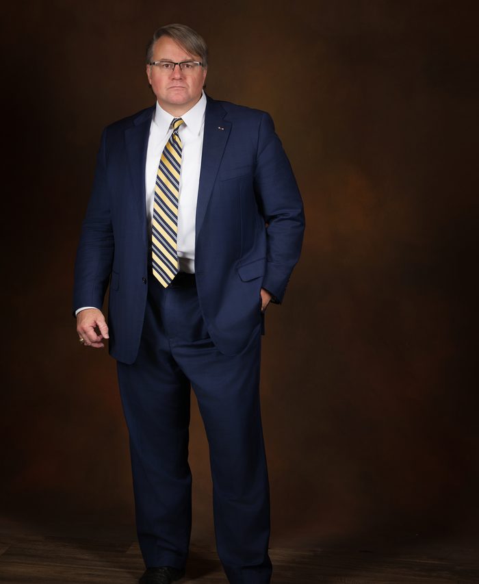 Colonel Mark Braswell standing, ready to take your call